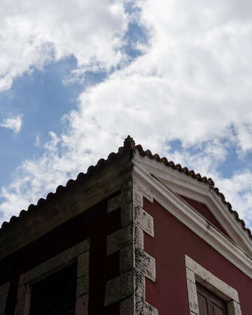 A vertical low angle shot of an old building under the cloudy sky