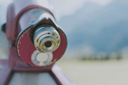 A closeup selective focus shot of a red binocular with zooming switches on the scrollerの写真素材