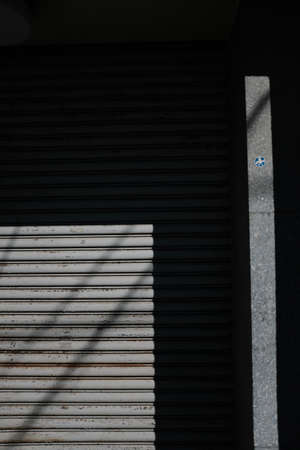 A vertical shot of gray steel roller shutter garage door