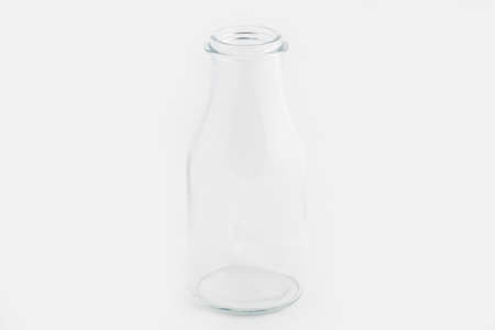 A closeup shot of a glass bottle isolated on a white background