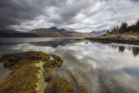 A gloomy day at the lake surrounded by hills and mountains in Mull, Inner Hebrides, Scotland, UK