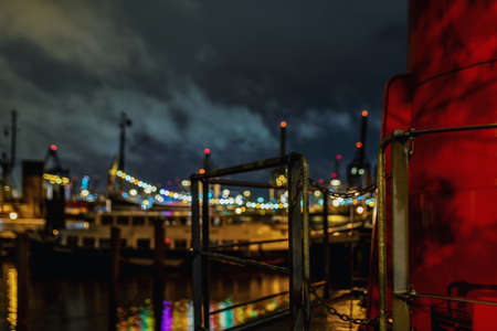 A closeup shot of iron railings next to the river shore with  a blurred backgroundの写真素材