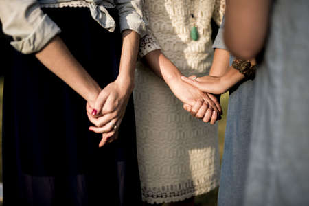 A closeup shot of female blessing others while holding their handsの写真素材