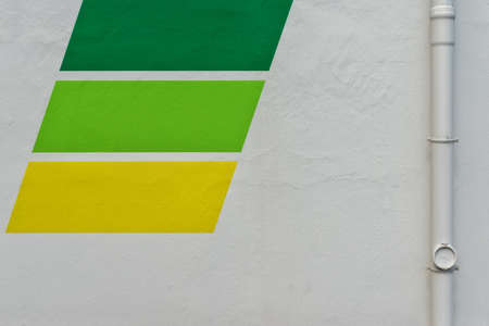 A horizontal shot of a white wall with green and yellow textures - perfect for a cool wallpaper or...