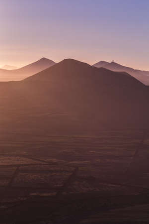 A breathtaking scenery of an erg with high hills with the beautiful sunset in the backgroundの写真素材