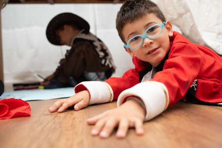 The small children dress up like pirates playing together indoors
