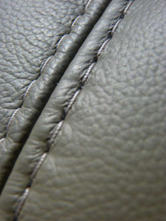 A vertical shot of an expensive leather sofa stitched with a black threadの写真素材