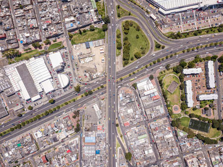 An aerial view of a landscape of a city with a lot of highways, buildings, and transportation during...