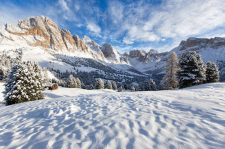 A beautiful snowy landscape with the mountains in the backgroundの写真素材