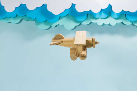 Paper figurines of clouds and a wooden plane