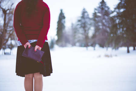 A closeup shot from behind of a female holding the bible with a blurred backgroundの写真素材