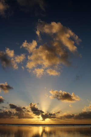 A vertical shot of the magical setting of the sun in Rarotonga
