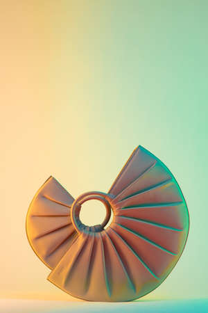 A vertical shot of minimalistic trendy purses on a colorful background
