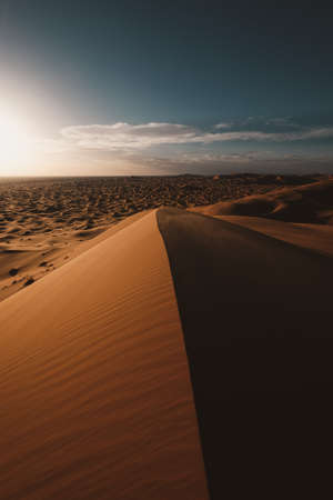 A vertical shot of the beautiful desert under the blue sky captured in Moroccoの写真素材