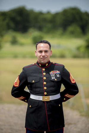 A shallow focus shot of a person in a military suit with badges