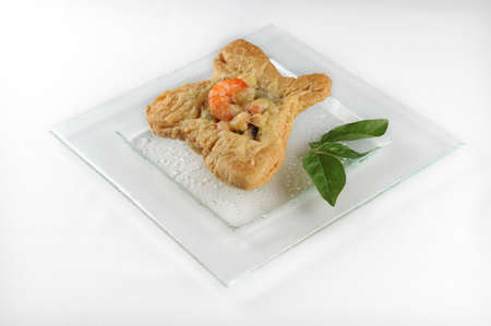 An isolated shot of a white plate with puff pastry with shrimps - perfect for food blog or menu usageの写真素材