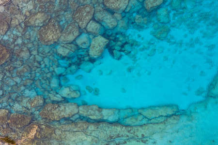 A high angle shot of beautiful rock formation under the ocean - great for a cool backgroundの写真素材