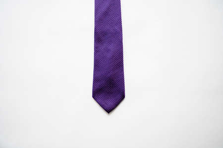 An overhead shot of a purple tie on a white surfaceの写真素材