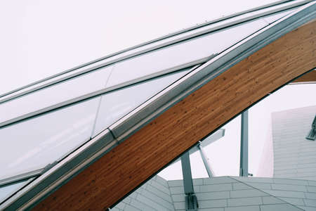 A closeup shot of a wooden plank in front of a white building