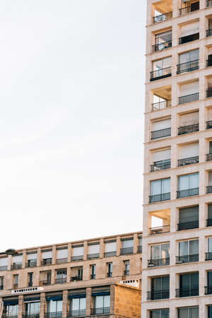 A vertical low angle shot of a residential building with beautiful balconies