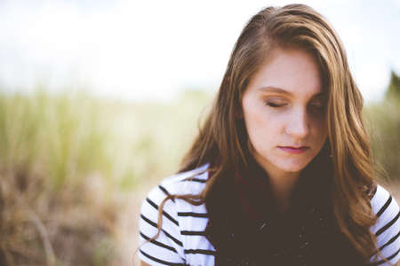 A shallow focus shot of a female praying while her eyes are closed