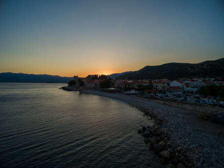 A breathtaking shot of the sun rising over the beach in Samos, Greeceの写真素材