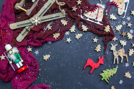 A high angle shot of a dark surface with Christmas festive decorations
