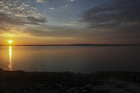 Sun rising over still water on Blue Hill Bay, Maineの写真素材