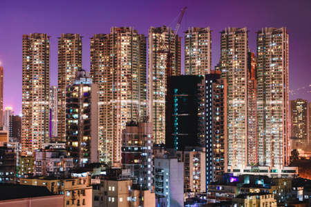 A beautiful cityscape with illuminated buildings at night in Hong Kong, China