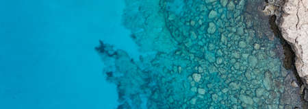 An aerial panoramic shot of rock formations in the Mediterranean seaの写真素材