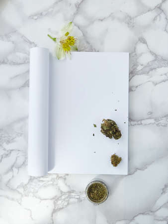A vertical shot of drugs in a white piece of paper on a white surface with beautiful patterns