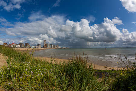 A beautiful shot of a sandy beach under the cloudy sky in Vlissingen, Zeeland, Netherlands