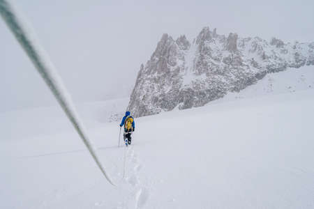 A beautiful shot of a person doing alpine climbing in the Mont Blanc Massif mountain in France