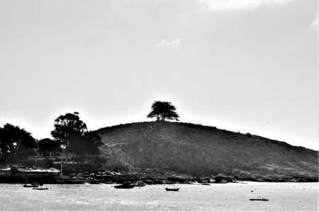 A greyscale shot of a hill at the river in Chile, South America