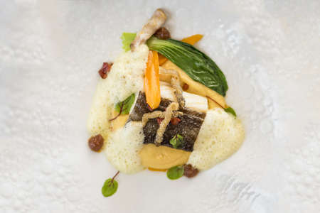 A delicious plate of dinner made with seafood and different kinds of exotic fruits and vegetables