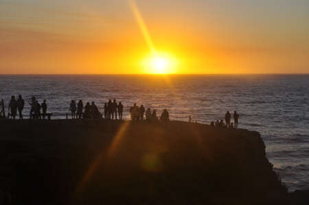 A breathtaking shot of the beautiful sunset with vibrant warm colors bringing beauty to the beachの写真素材