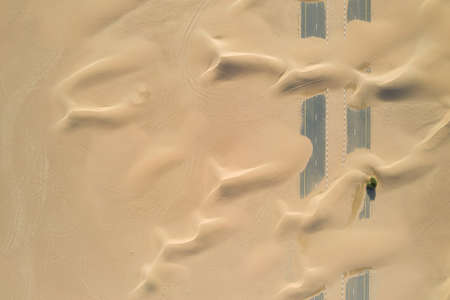 A closeup shot of roads of unfinished construction covered by the desert sands in the United Arab...