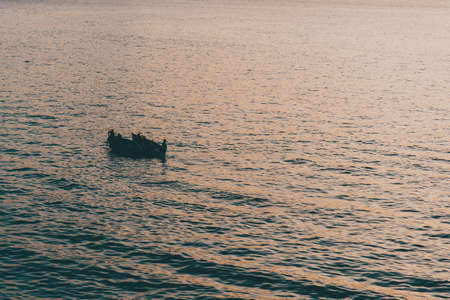 The two small boats sailing in the ocean in Guanabara Bay, Rio de Janeiro during the sunsetの写真素材