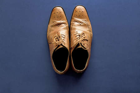 An overhead shot of shoes on a dark blue surfaceの写真素材