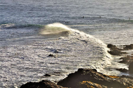 A bunch of surfers enjoying the splash of beautiful blue ocean waves