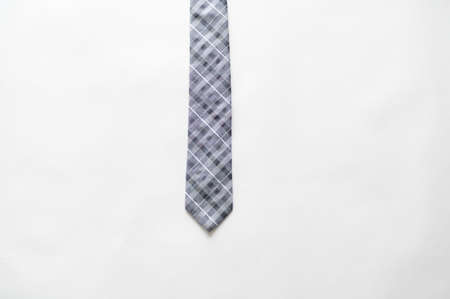 An overhead shot of a striped tie on a white surfaceの写真素材