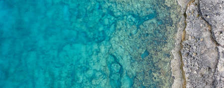 A high angle panoramic shot of a lot of rock formations in the ocean - great for a cool background
