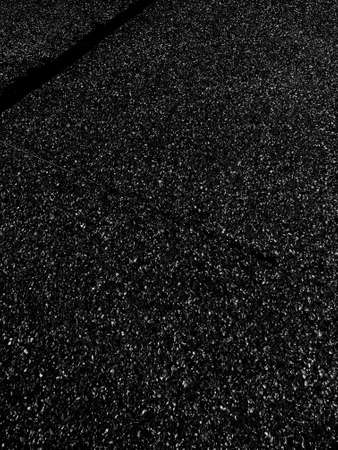 A vertical grey scale shot of the asphalt on the streetの写真素材