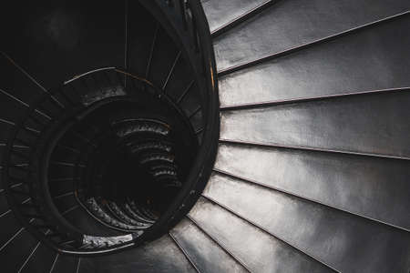 A grayscale top view shot of the spiral staircase - mystery conceptの写真素材