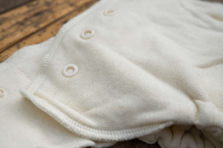 A closeup shot of organic white baby diapers on a wooden surface