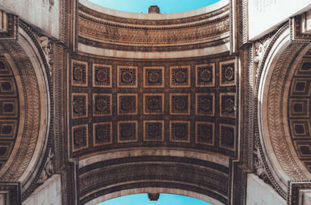 A low shot of a ceiling of the Arc of Triumph in Paris with beautiful engravings on itの写真素材