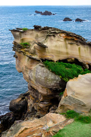 A vertical shot of a beautiful rock formation near the sea in Yehliu, Taiwan