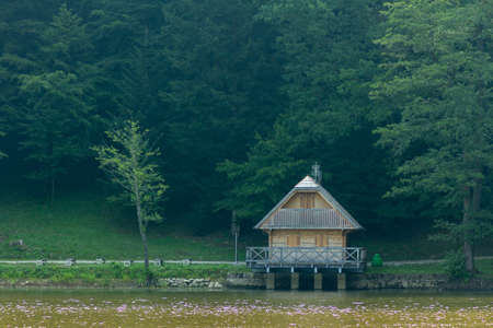 A small hut near the lake in the forest near Trakoscan, Croatiaの写真素材