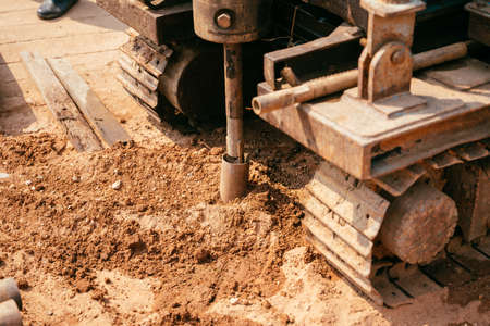 A close shot of a heavy machine digging the ground  at daytime