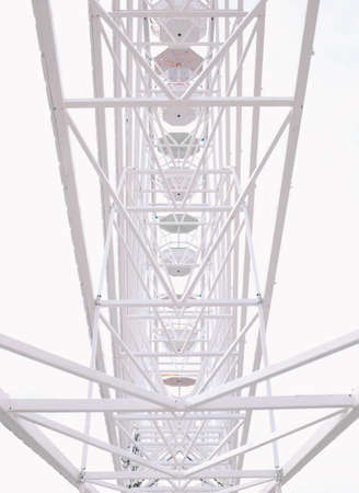 A closeup of the Ferris Wheel carousel during a ride with a nice white backgroundの写真素材